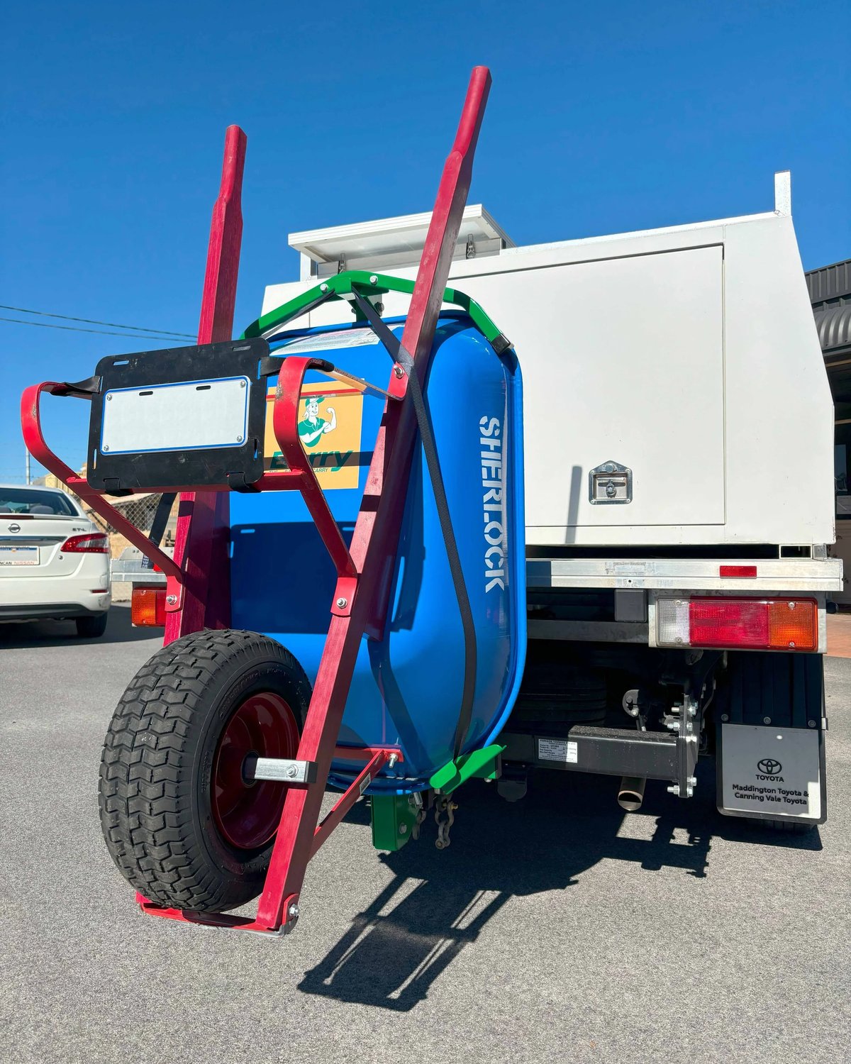 Complete Kit in use: Barry carrying a wheelbarrow on a ute tow hitch with the auxiliary plate holder fitted. Wheelbarrow not included.